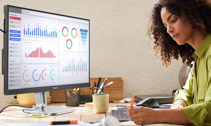 A woman is working with the tco edge certified Philips Monitors